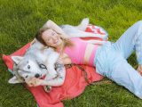 Woman and Dog Lying on a Blanket